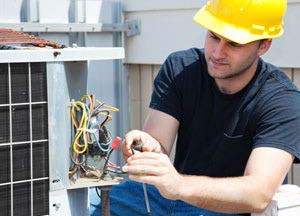 HVAC technician repairing an AC unit